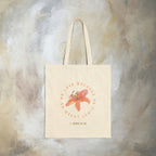 We love because he first loved us tote bag