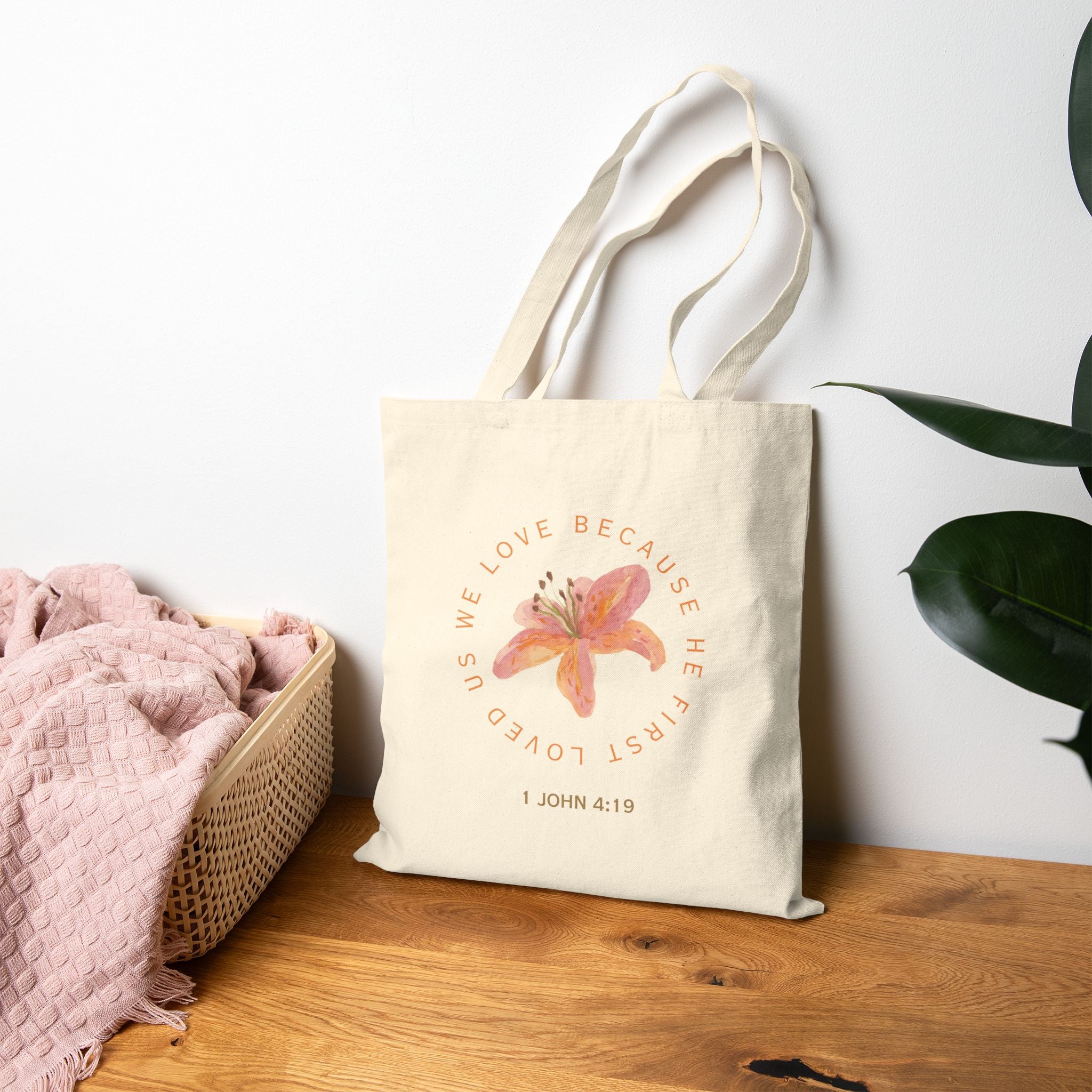 We love because he first loved us tote bag