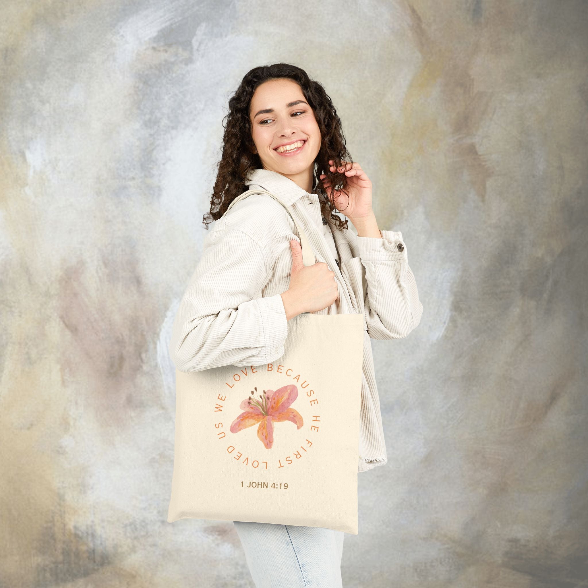We love because he first loved us tote bag